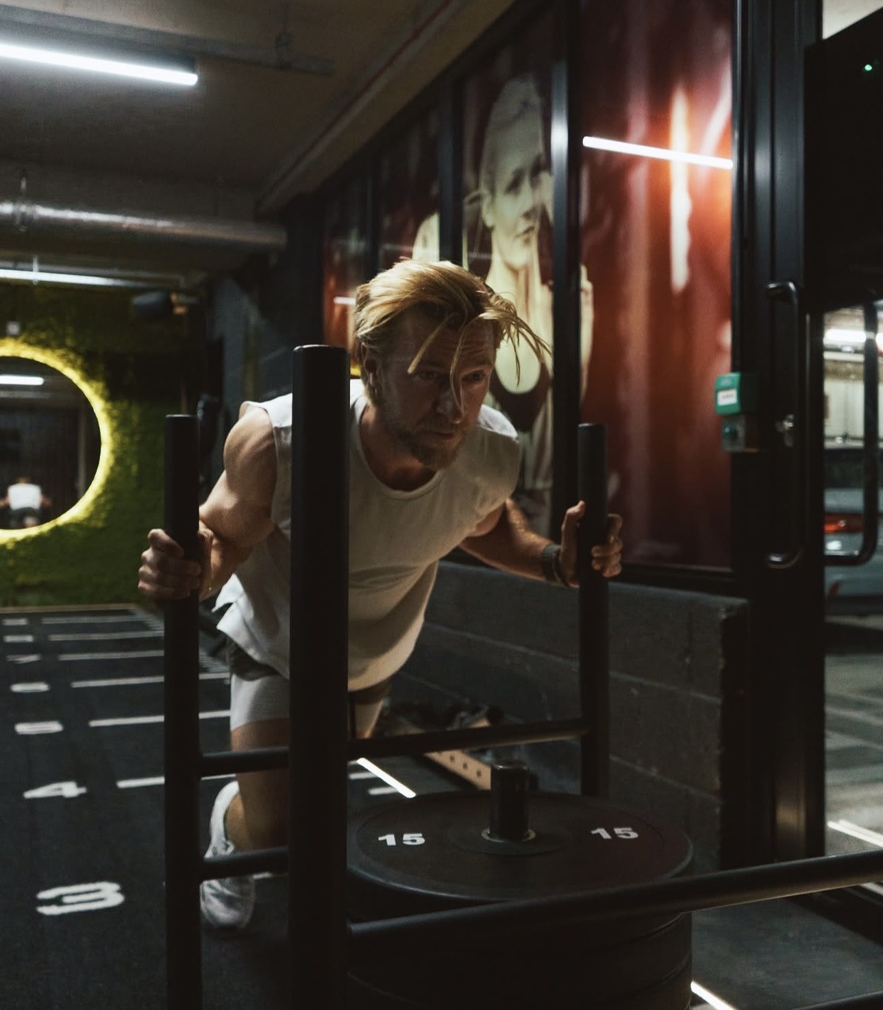A member completing a sled push